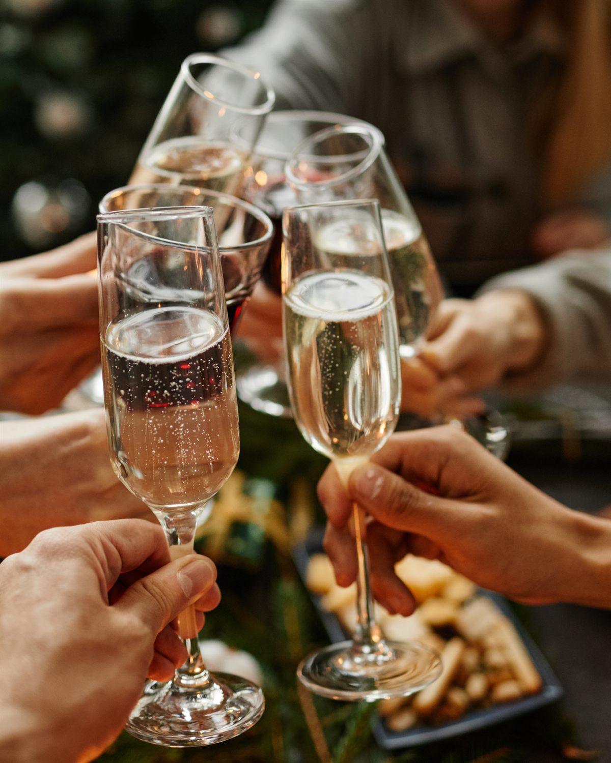 Guests raising a champagne toast at a Christmas celebration